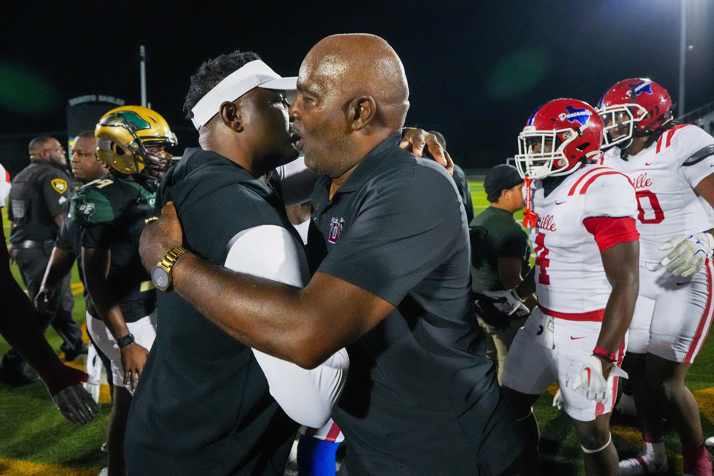 Duncanville head coach Reginald Samples (right) hugs DeSoto head coach Claude Mathis after...