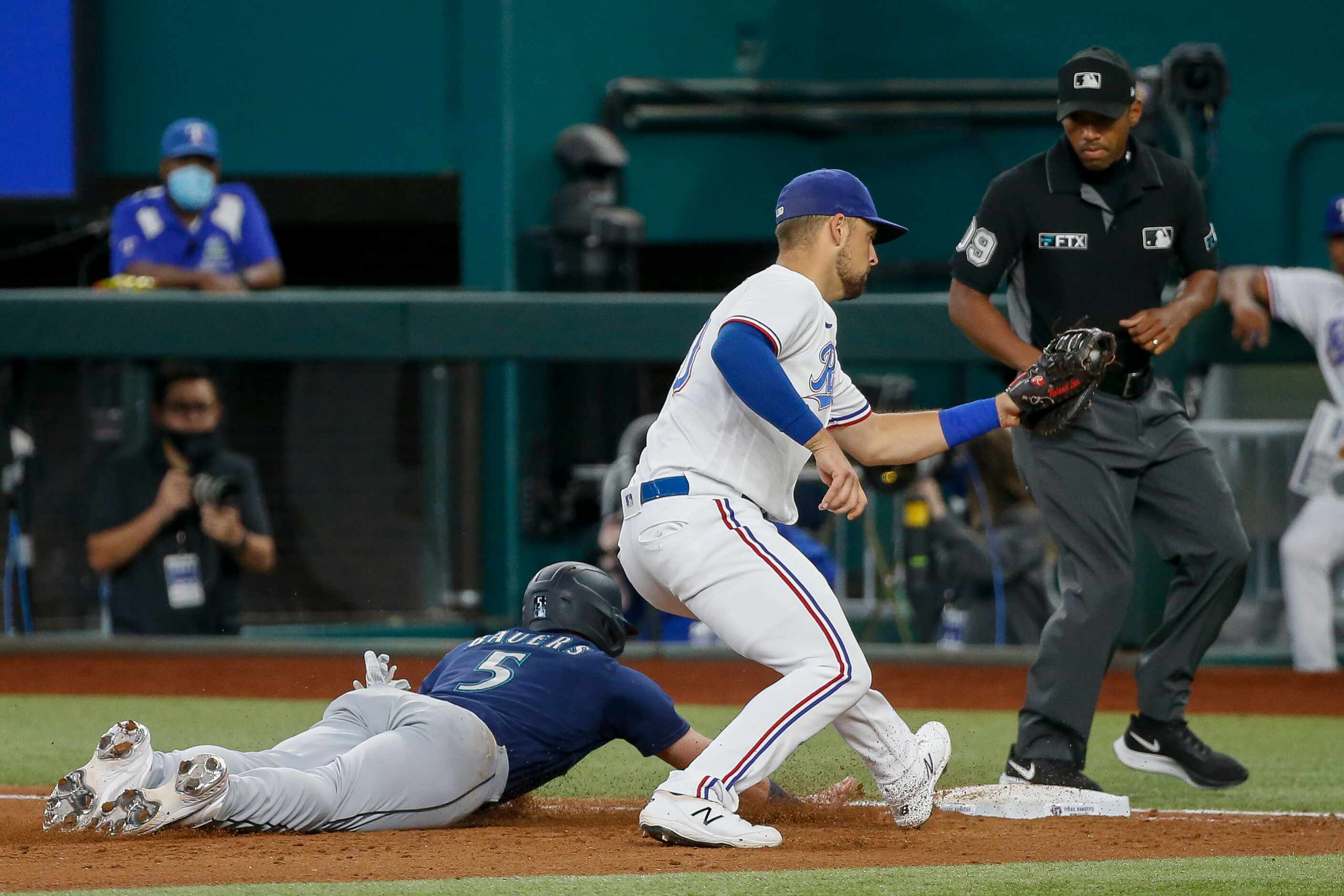 Seattle Mariners right fielder Jake Bauers (5) slides for first base as Texas Rangers first...