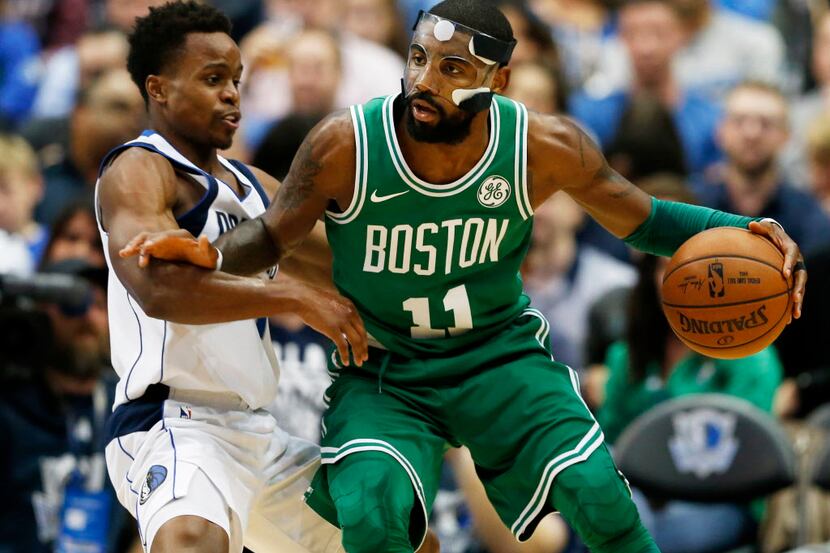 Boston Celtics guard Kyrie Irving (11) posts up Dallas Mavericks guard Yogi Ferrell (11) on...