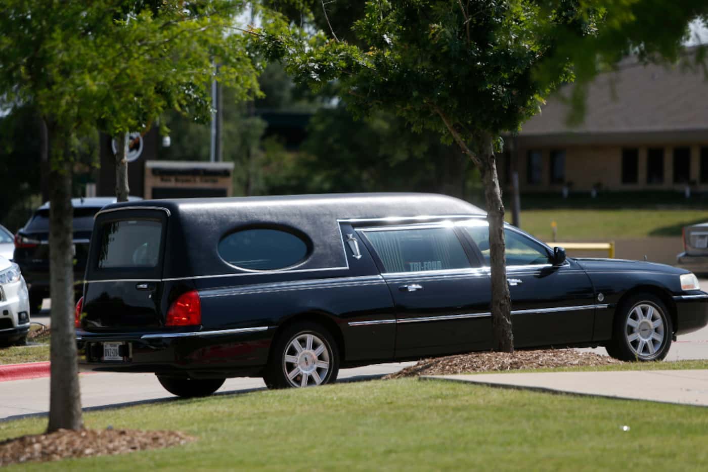 A hearse carries former councilman Don Hill away from Concord Church after his memorial...