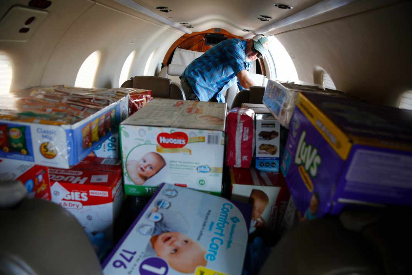 Warren Brown, pilot, unloads donations given in Georgetown, Texas, a week after Hurricane...
