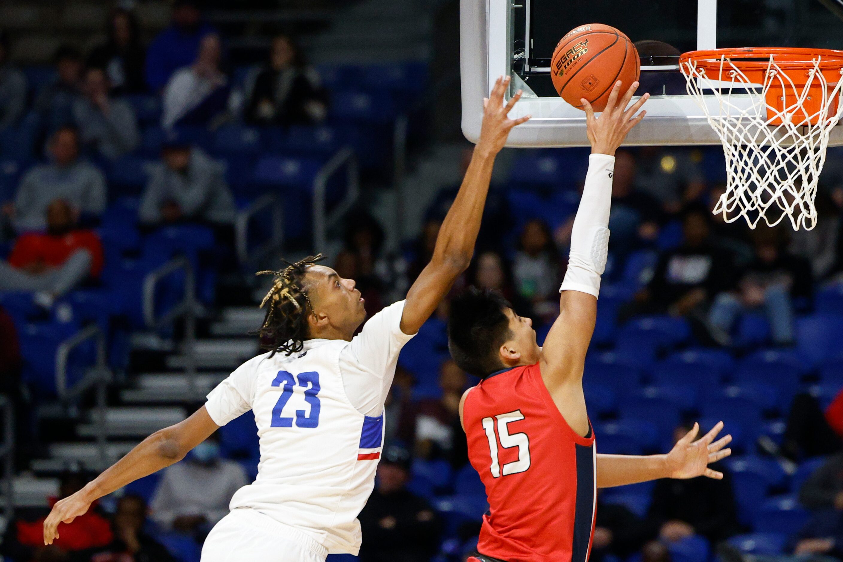 Duncanville forward Cameron Barnes (23) contests a shot from Humble Atascocita guard Landyn...