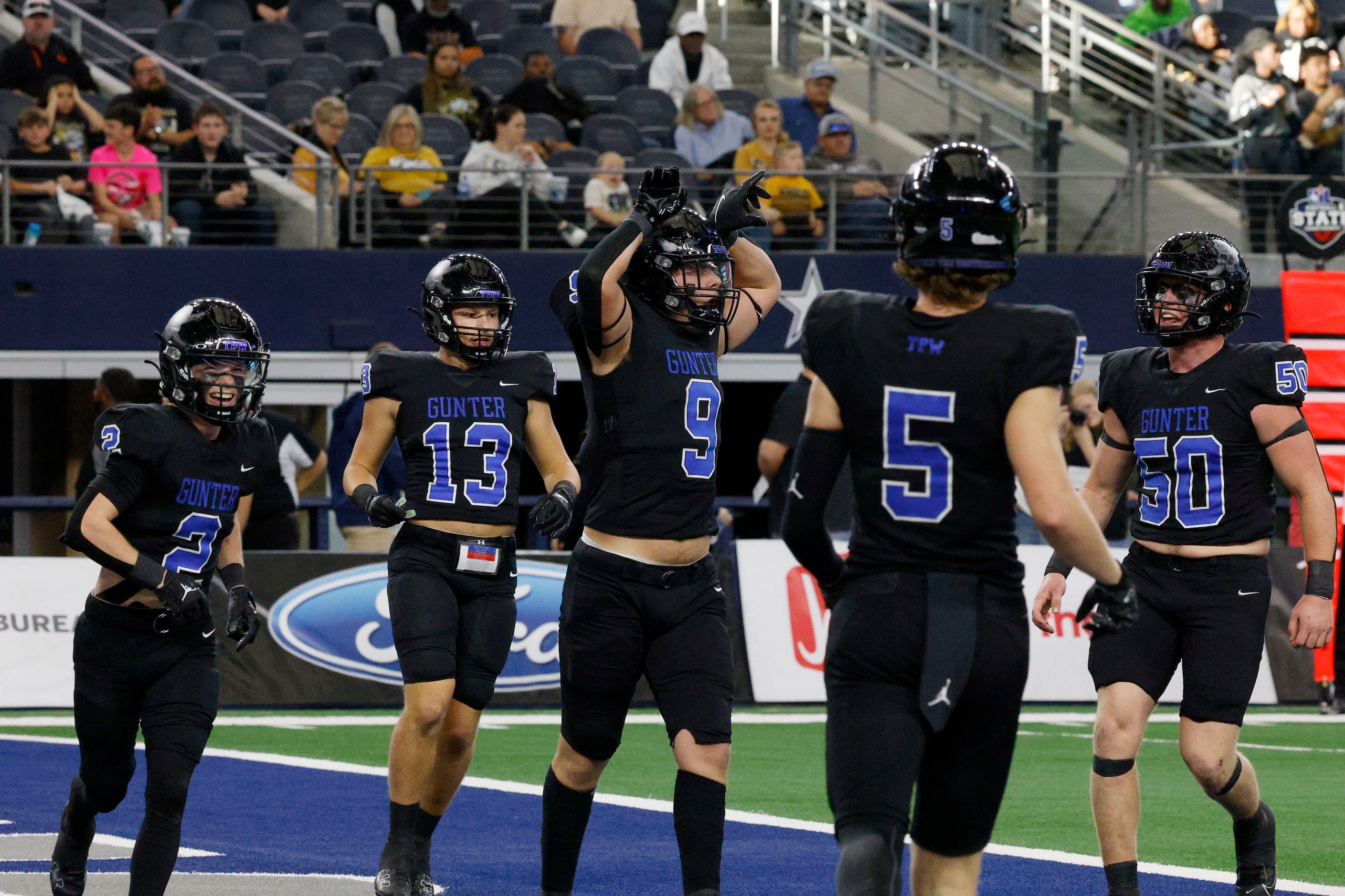 Gunter's  Cole Harpole (9) celebrates with his teammates after scoring a touchdown against...