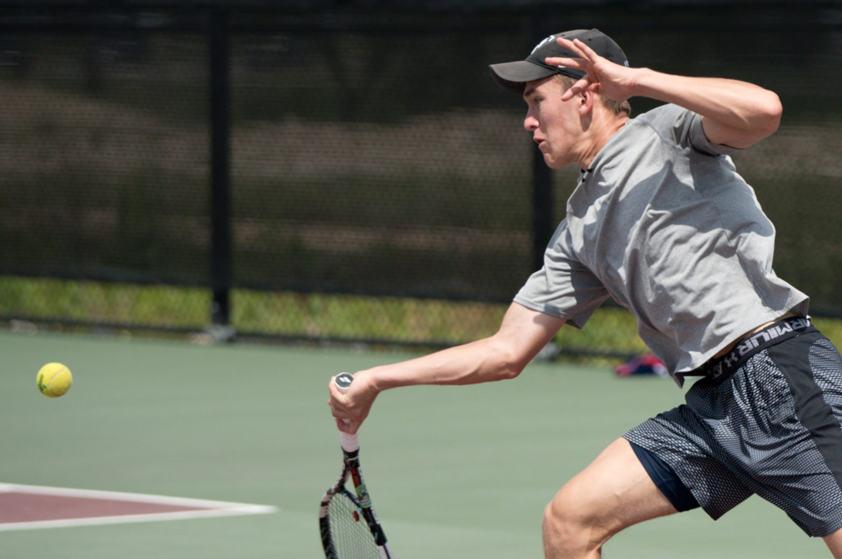 Southlake Carroll's Nick Ryniak returns the ball in a doubles match with teammate Gino...