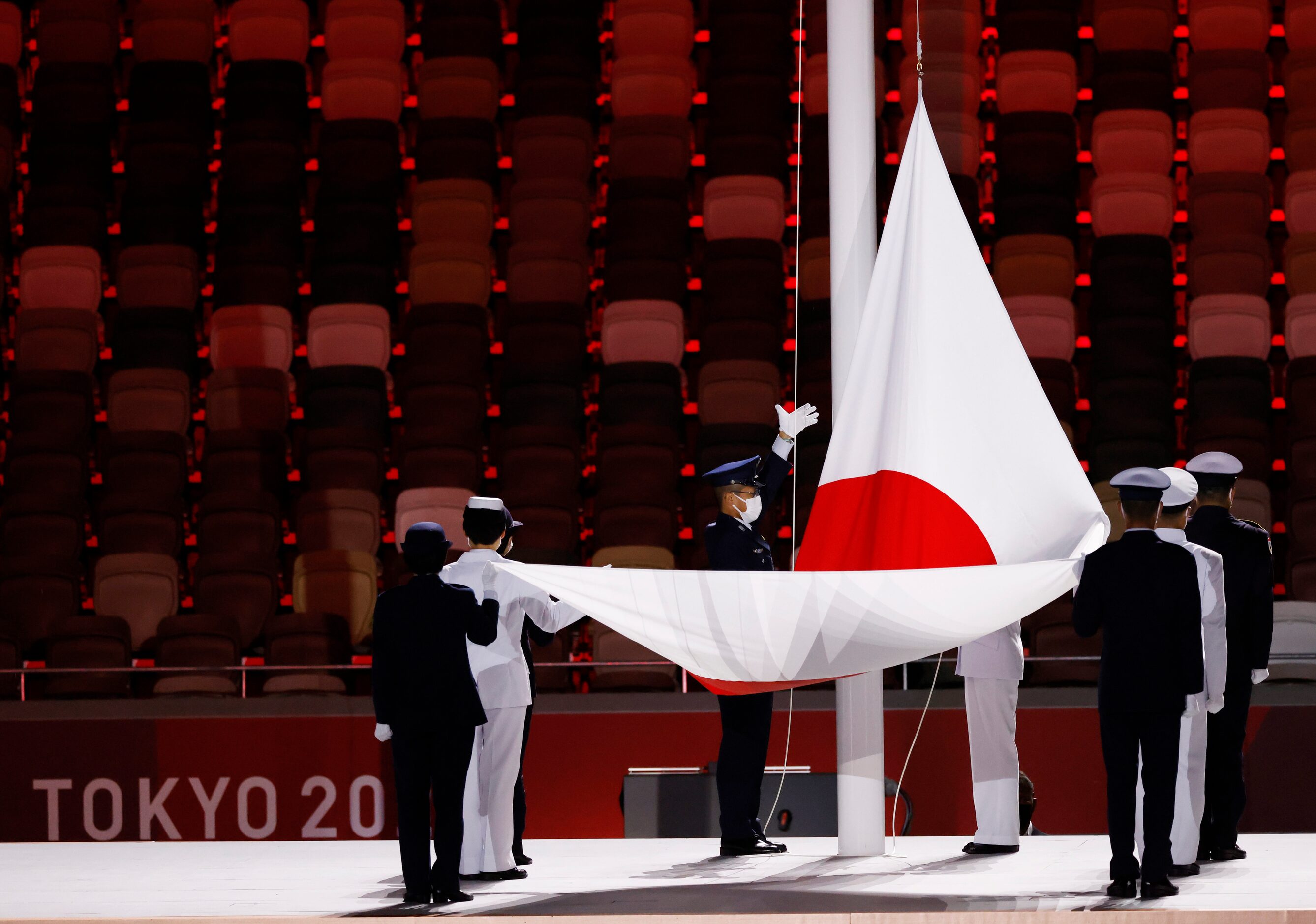 The flag of Japan is raised during the opening ceremony for the postponed 2020 Tokyo...