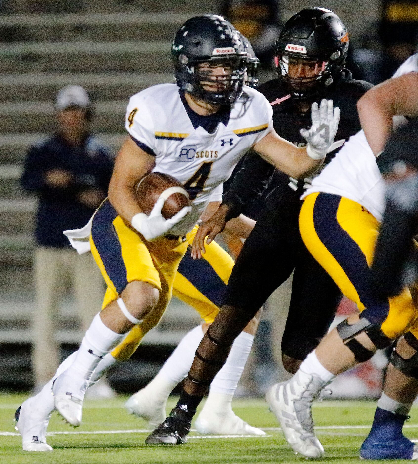 Highland Park High School running back Christian Reeves (4) runs behind his blockers during...