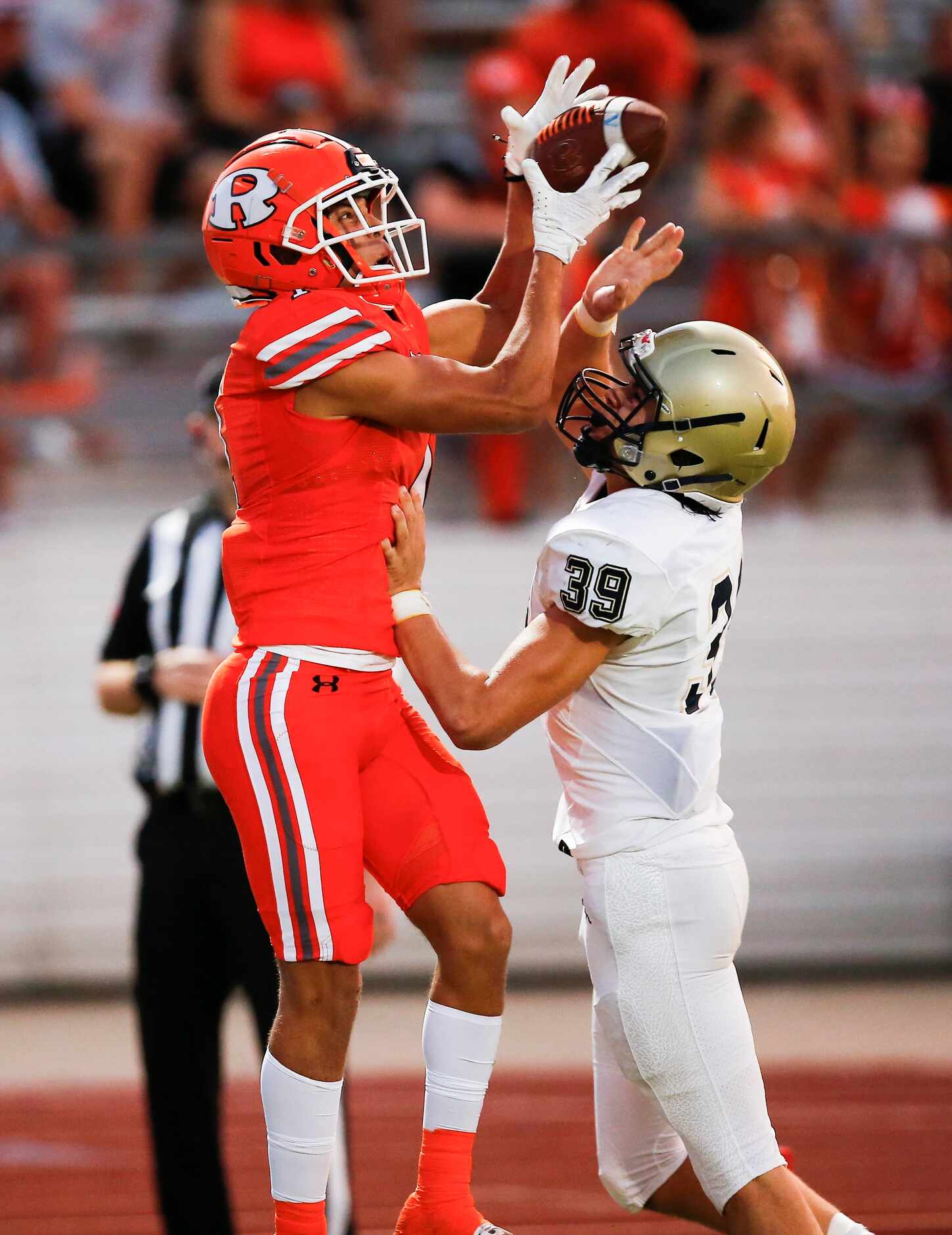 Rockwall junior wide receiver Aiden Meeks (1) catches a pass as Jesuit sophomore defensive...