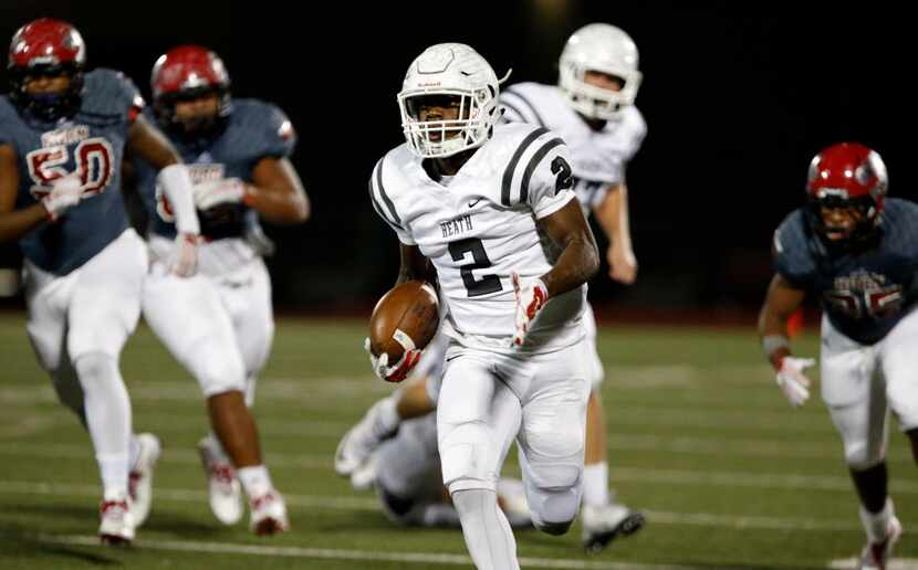 Rockwall-Heath High's Tanner McCalister (2) runs for a touchdown during the first half of a...