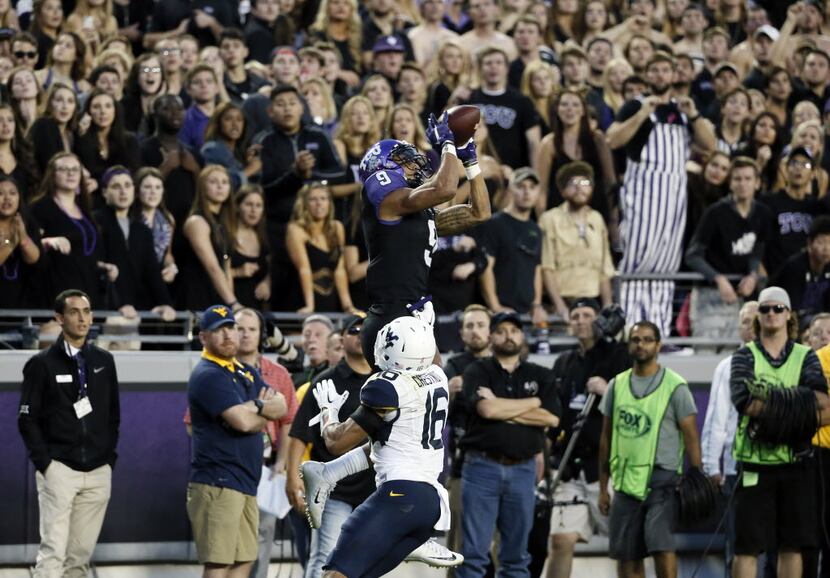 TCU's Josh Doctson (9) leaps up to grab a pass over West Virginia cornerback Terrell...