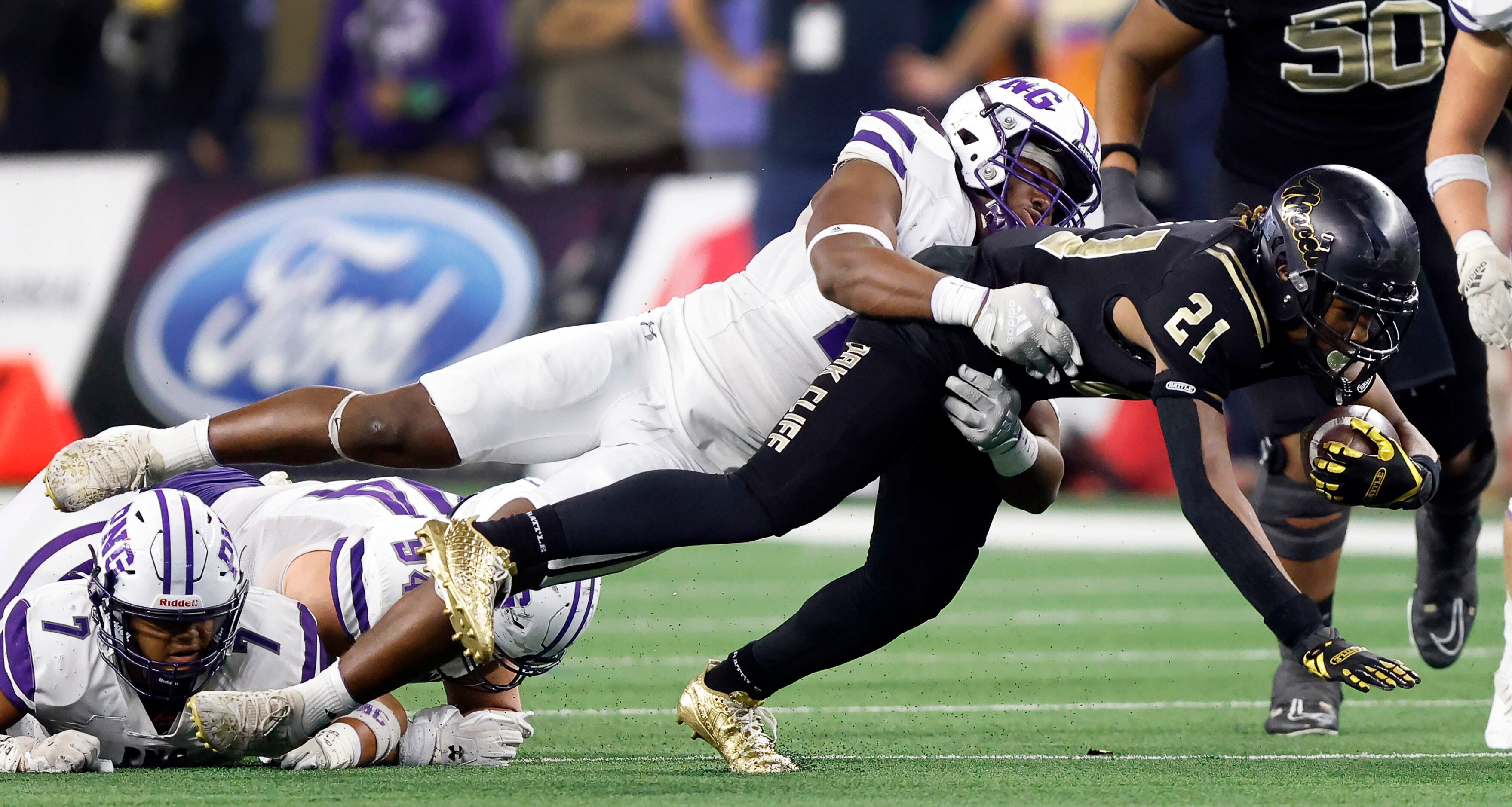 South Oak Cliff running back Danny Green (21) dives for extra yards as he’s brought down by...