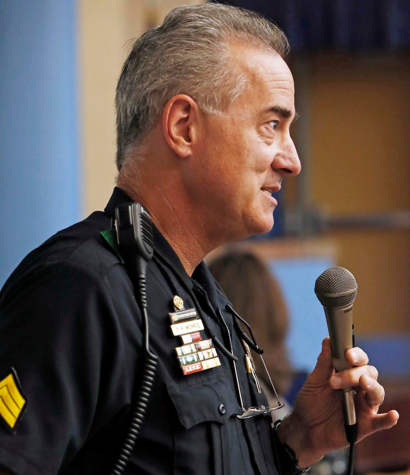 
DISD trustee Dan Micciche (top) and DPD Sgt. Paul Morris speak to the residents of the...