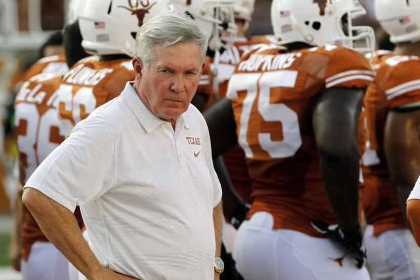 Texas head coach Mack Brown eyes his players' warmups before the start of the Longhorns 56-7...
