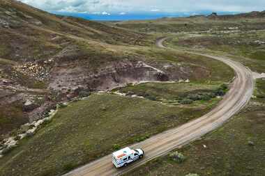 A Lower Valley Fire District ambulance drives a dirt road through the Horsethief Canyon...