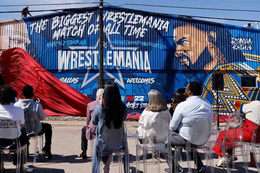 Crews drop the curtain on a WrestleMania mural in West Dallas, March 3, 2022. Superstar Drew...