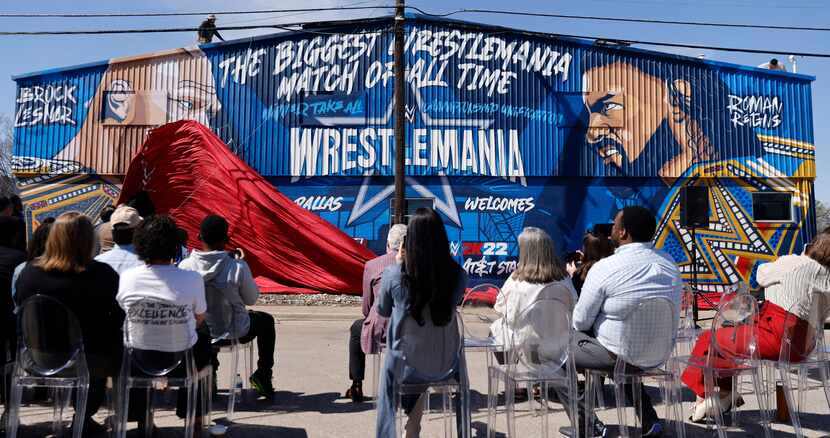 Crews drop the curtain on a WrestleMania mural in West Dallas, March 3, 2022. The mural was...
