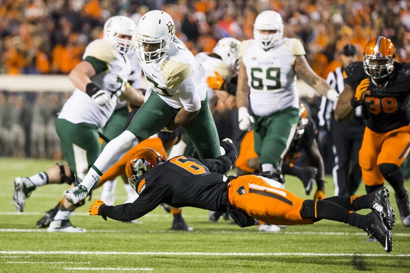 Baylor quarterback Chris Johnson (13) tries to hurdle Oklahoma State cornerback Ashton...