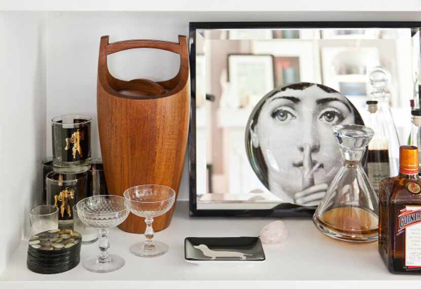 Flannery's living-room built-in bar, kitted out with Fornasetti plate and 1970s erotica...
