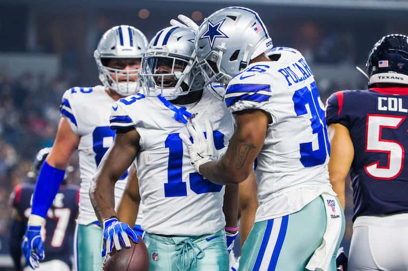 Dallas Cowboys wide receiver Michael Gallup (13) celebrates with running back Tony Pollard...