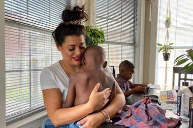 Jantzen Verastique hugs Jonah, 4, one of her two adopted sons, a year after she was shot...