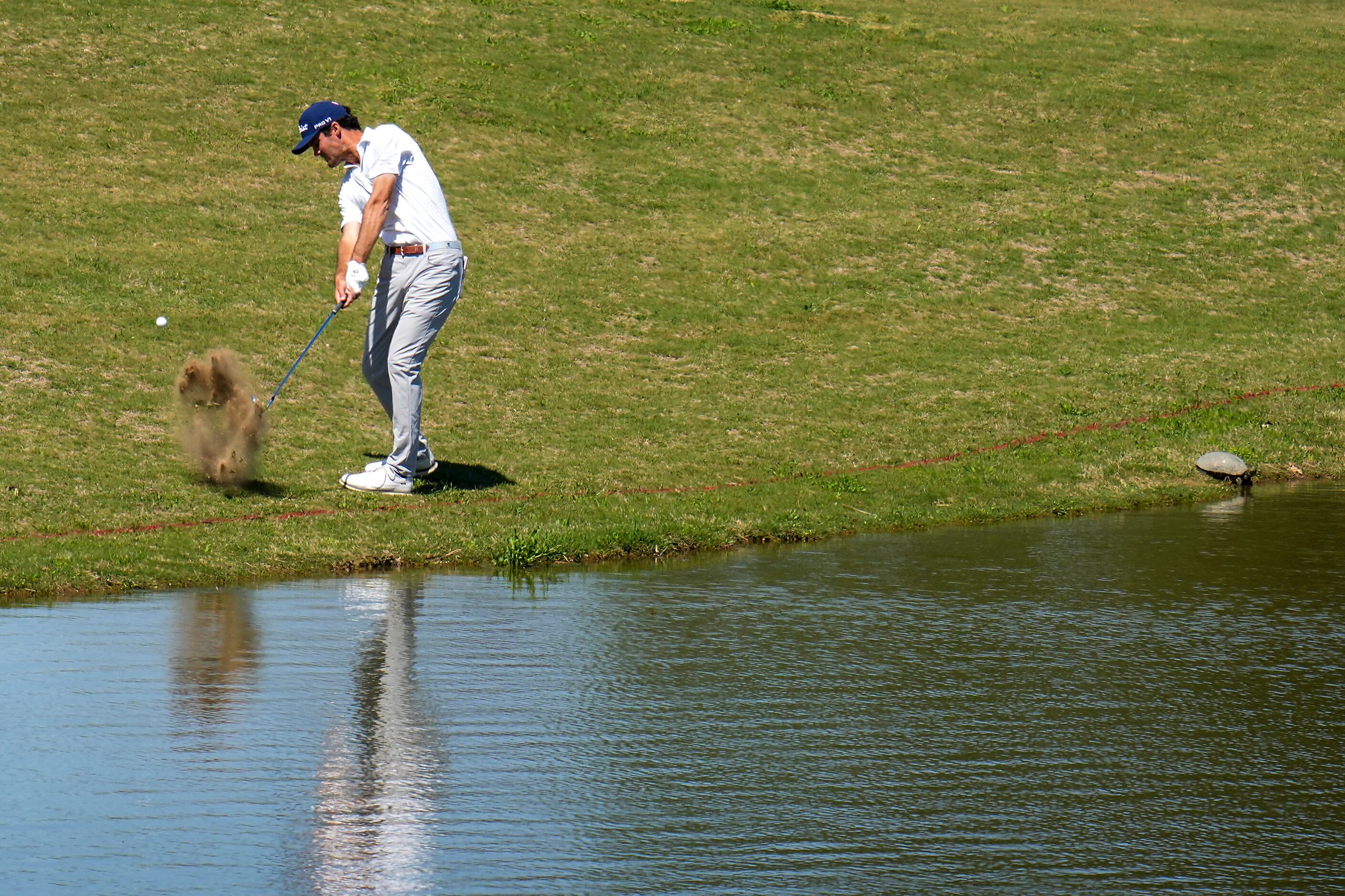 Jackson Suber hits from the edge of the fairway on the 13th hole during the final round of...