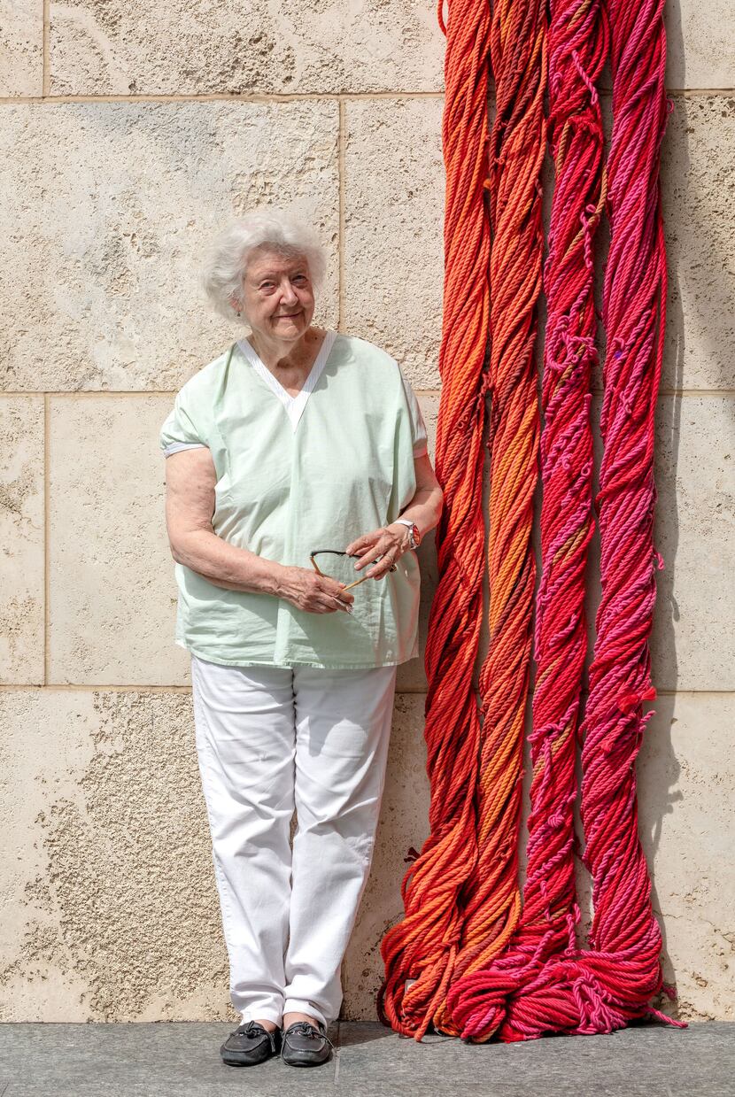 Artist Sheila Hicks poses with a part of her "Sheila Hicks: Seize, Weave Space" 2019...