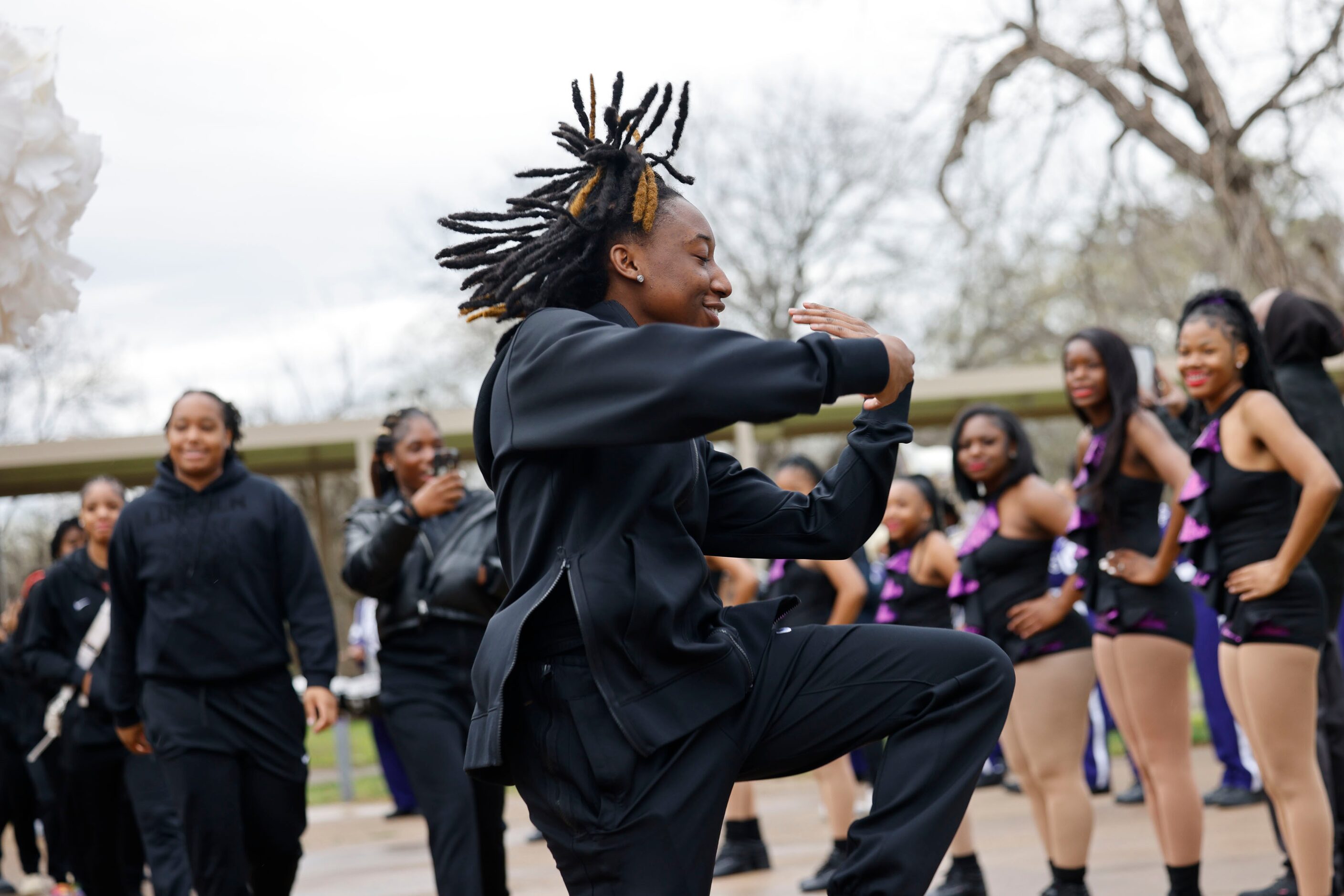 Lincoln High School basketball player Kayla Crowder dances as heading to a bus with her...