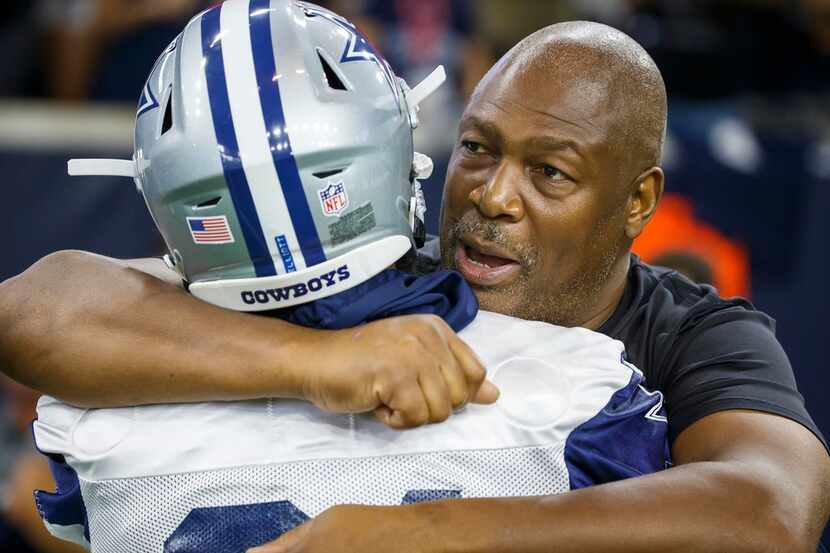 Former Cowboy Charles Haley hugs Dallas Cowboys running back Ezekiel Elliott during the...