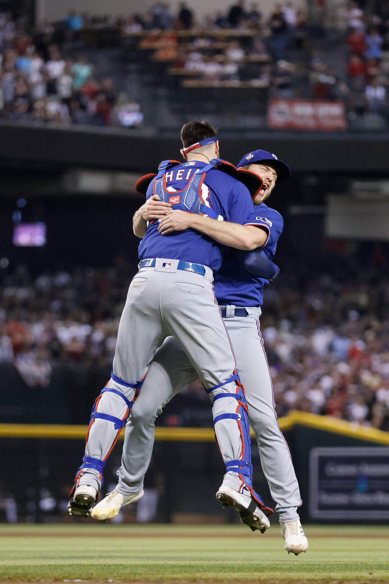 Texas Rangers relief pitcher Josh Sborz (right) and catcher Jonah Heim (28) celebrate their...