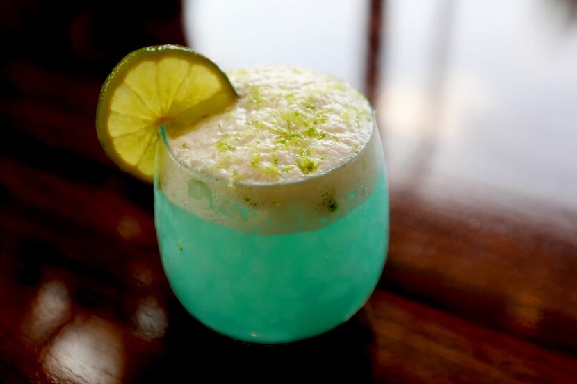 The Seafoam Surfer cocktail is made with with tequila, Grand Marnier, agave, lime and salty...