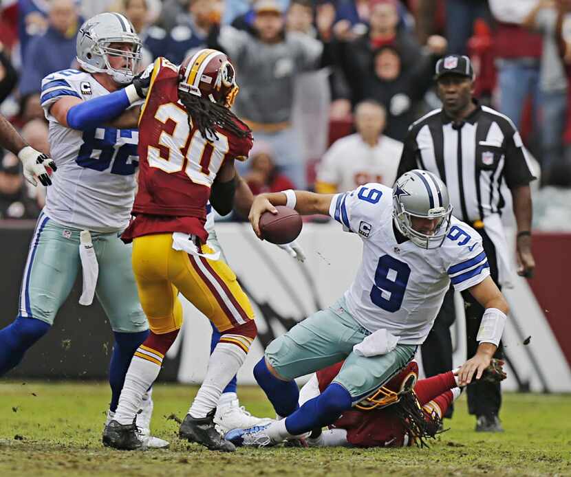 Dallas Cowboys quarterback Tony Romo (9) is sacked during the first half of their NFL game...