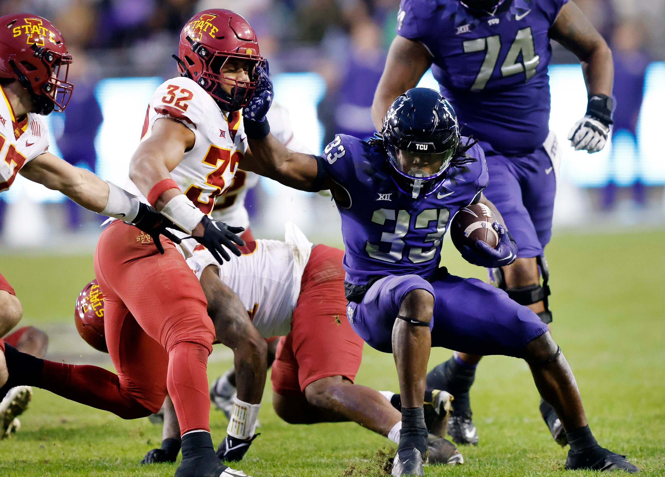 TCU Horned Frogs running back Kendre Miller (33) gives a stiff arm to Iowa State Cyclones...