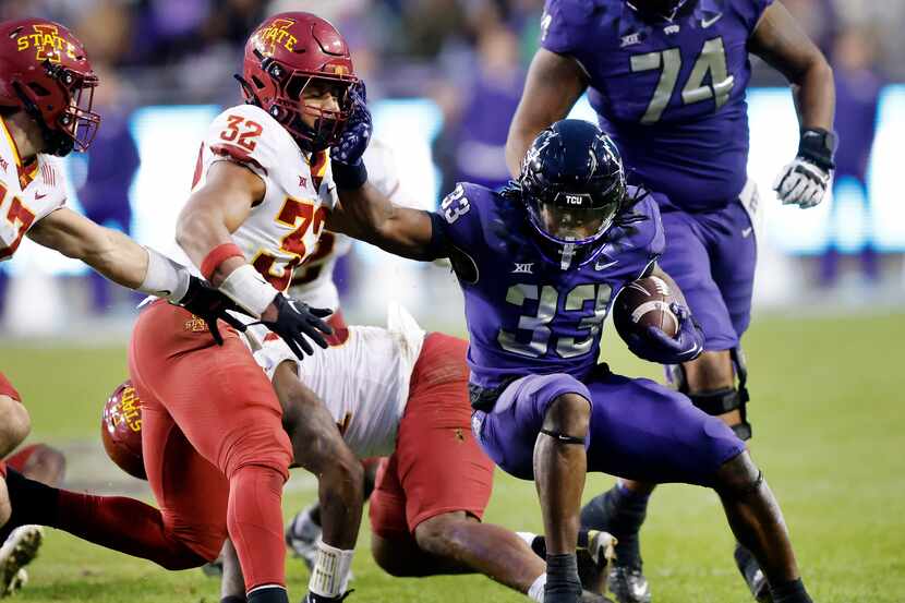 TCU Horned Frogs running back Kendre Miller (33) gives a stiff arm to Iowa State Cyclones...