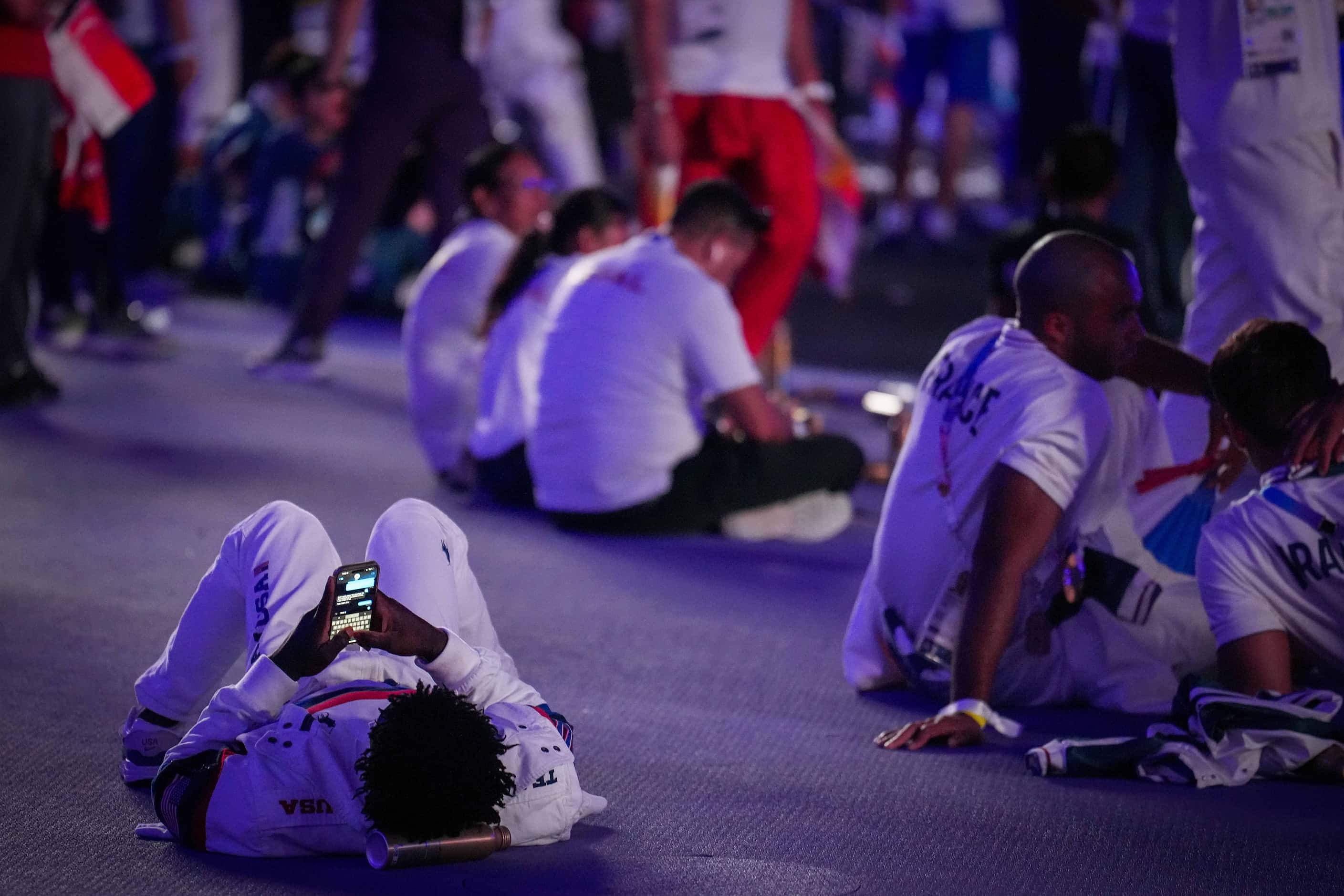 An American athlete relaxes on the ground during closing ceremonies for the 2024 Summer...