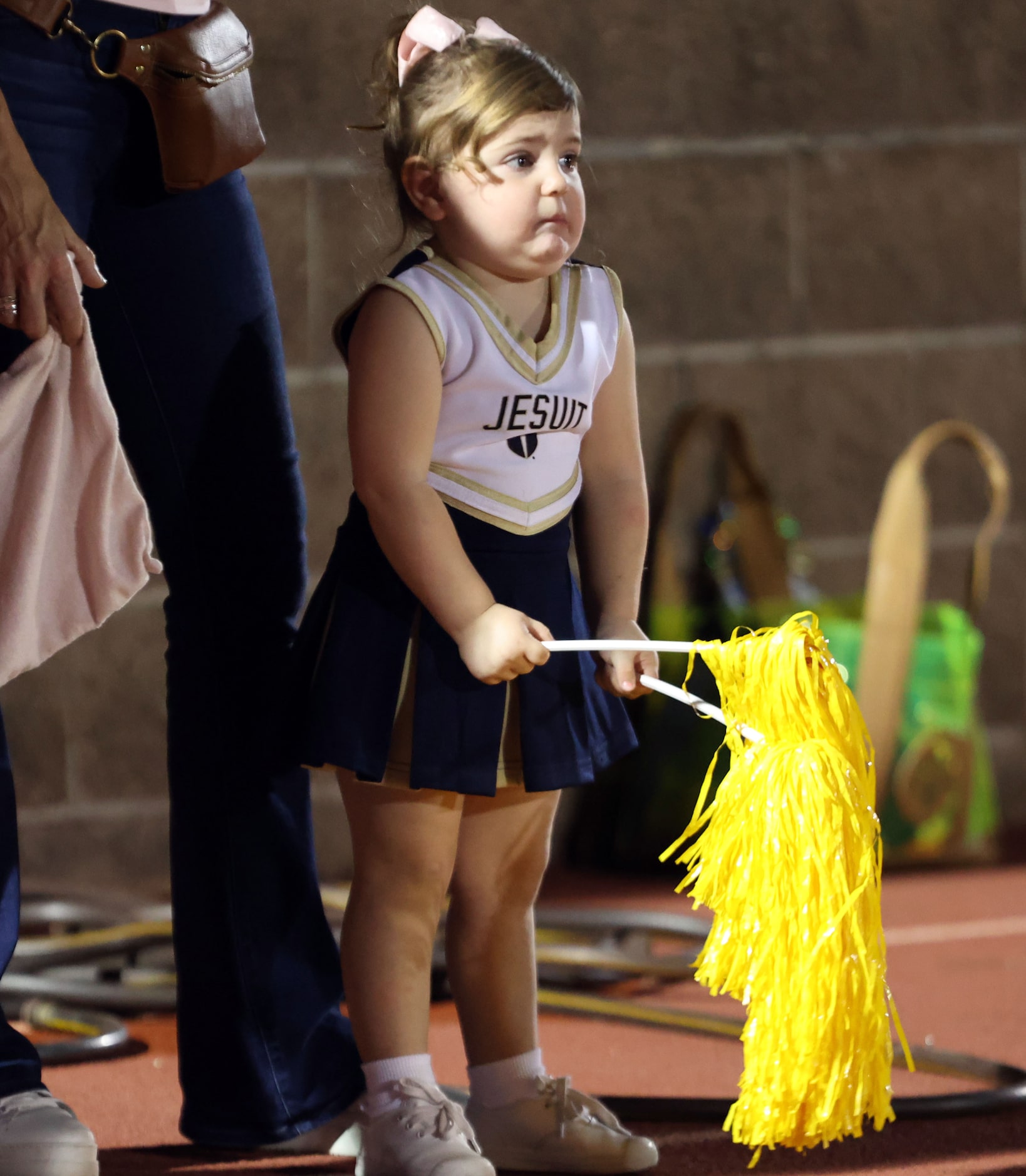 A little Jesuit cheerleader seems concerned by what she sees during the first half of a high...