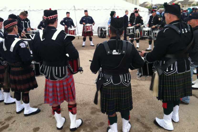 Pipe and drum corps members from several fire departments practice together before...