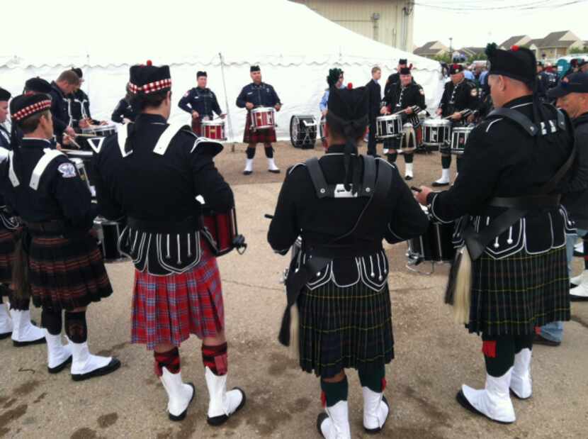 Pipe and drum corps members from several fire departments practice together before...