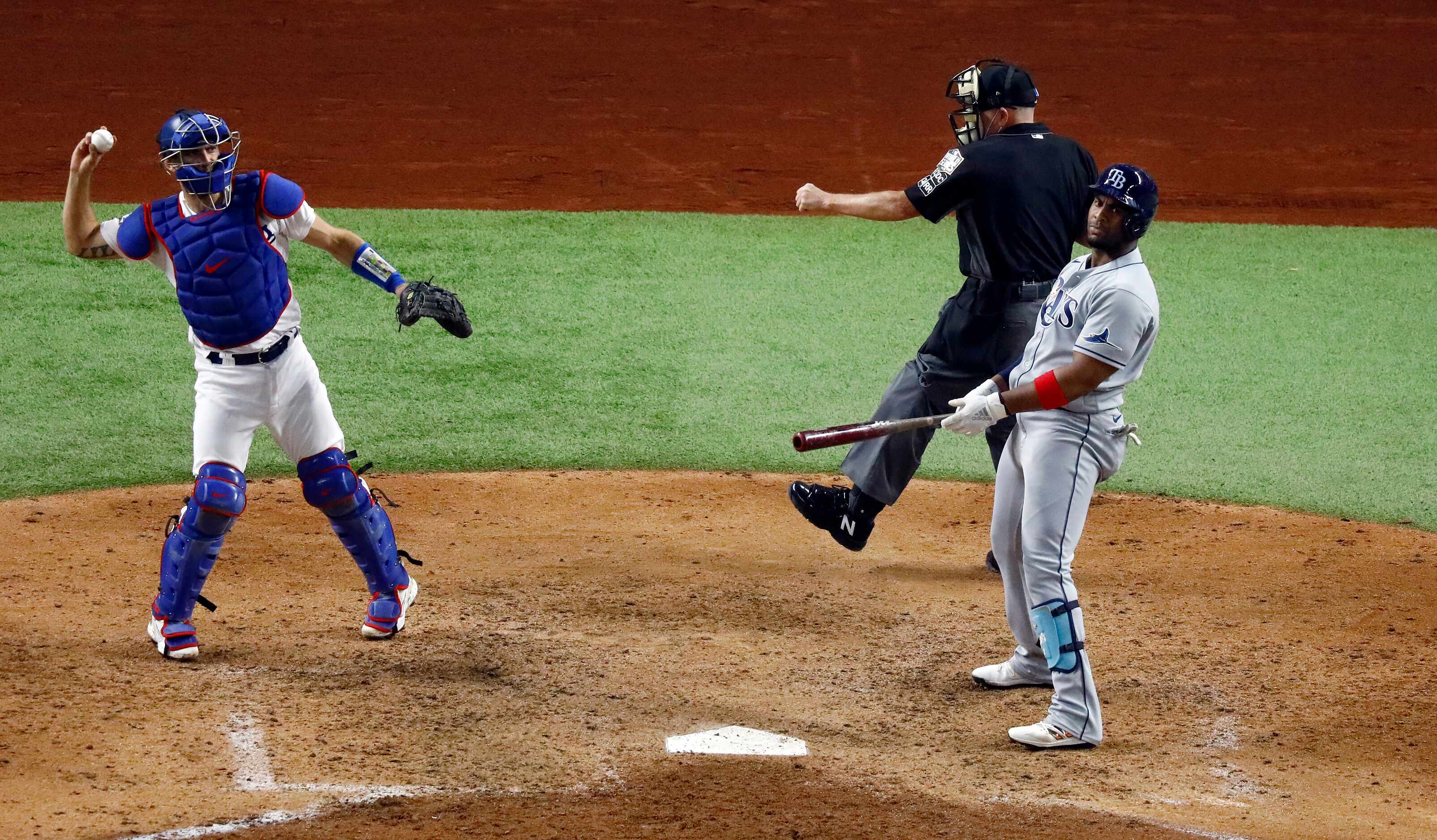 Tampa Bay Rays batter Yandy Diaz (2) reacts after striking out looking as home plate umpire...