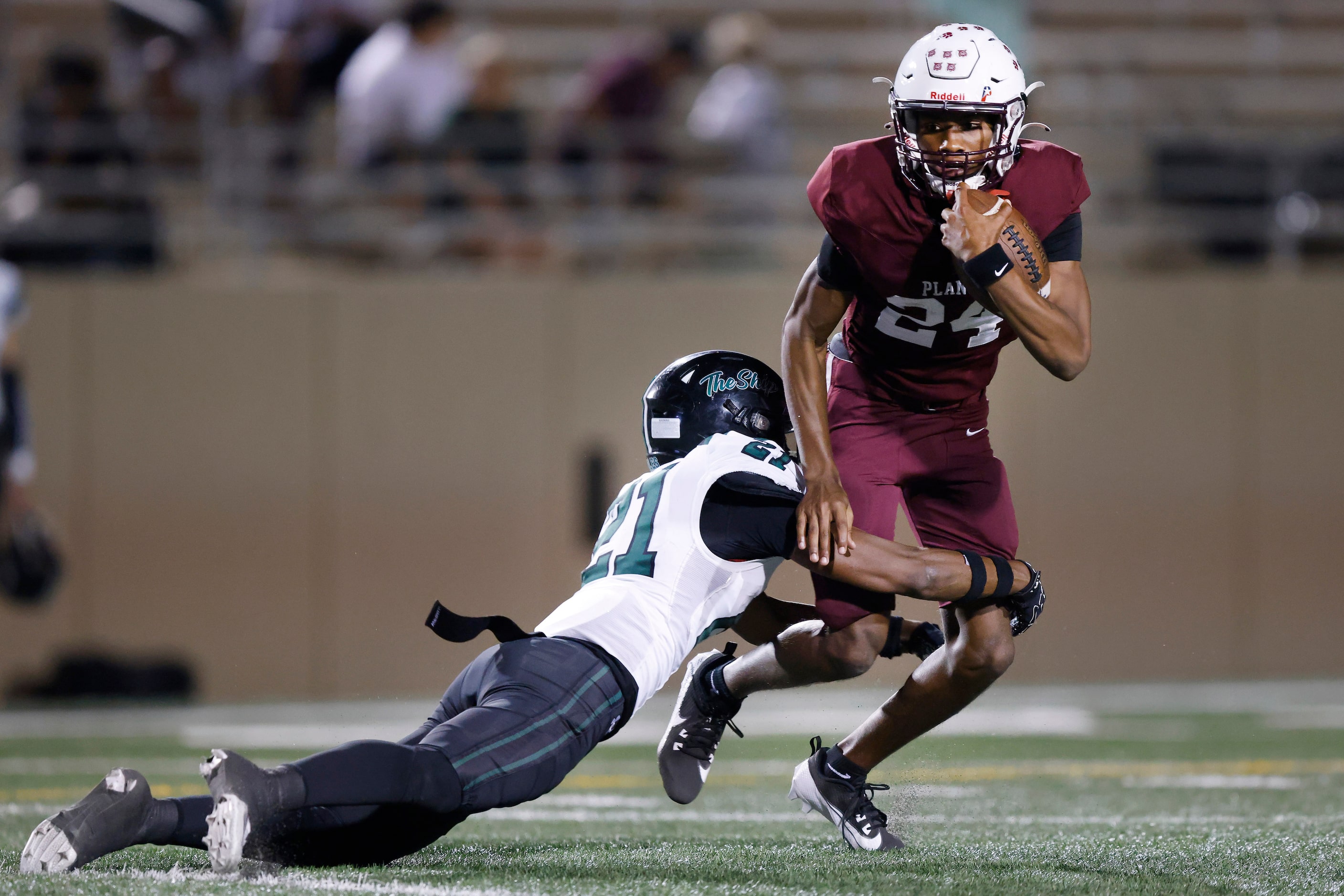 Prosper High’s DK Jamison (21) tackles  Plano High quarterback Tyree Fisher (24) during the...