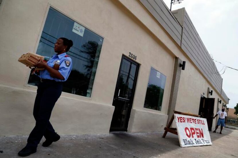 
Martha Walker picks up lunch from Black Jack Pizza on Martin Luther King Jr. Boulevard. The...