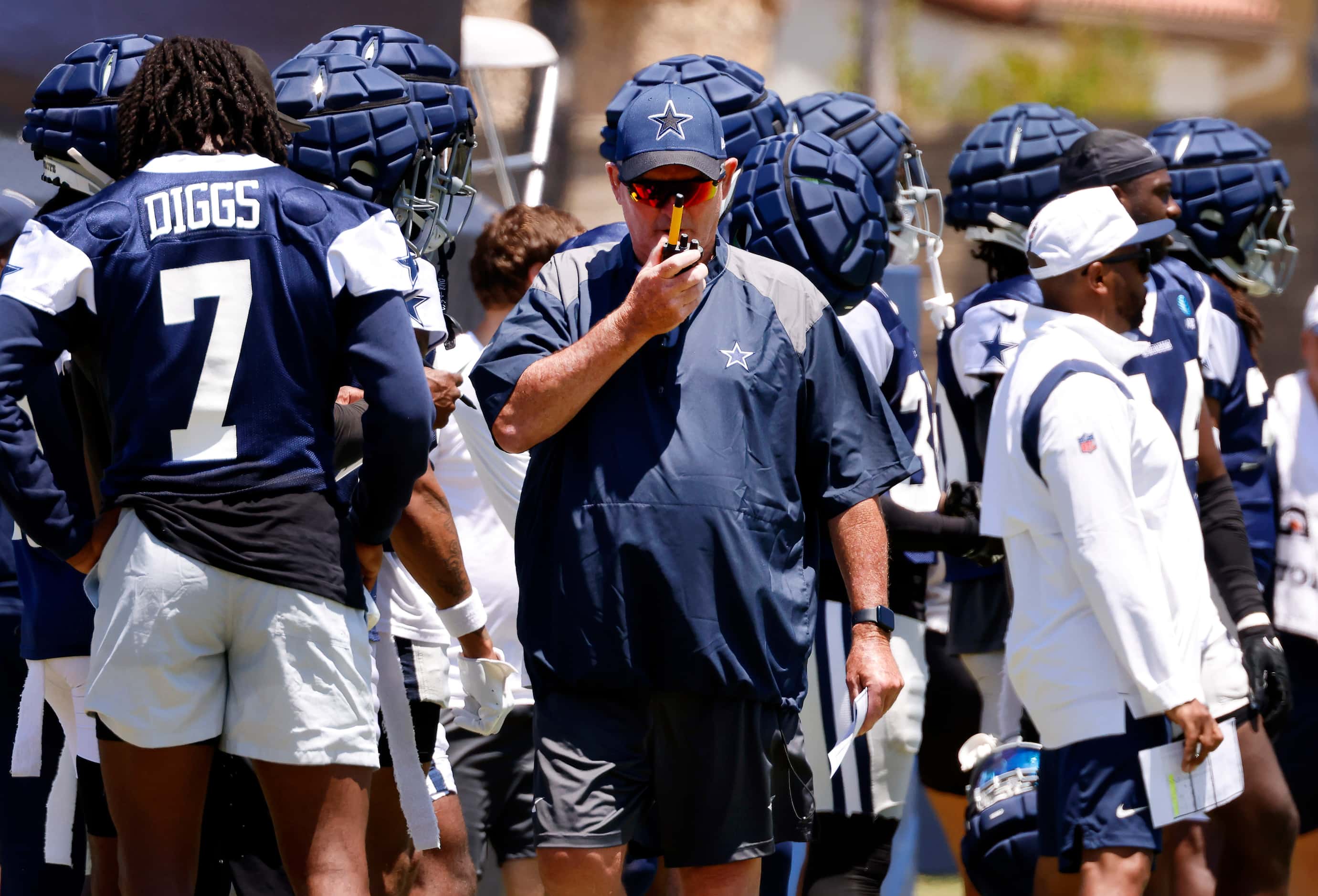 Dallas Cowboys defensive coordinator Mike Zimmer calls in play during training camp practice...