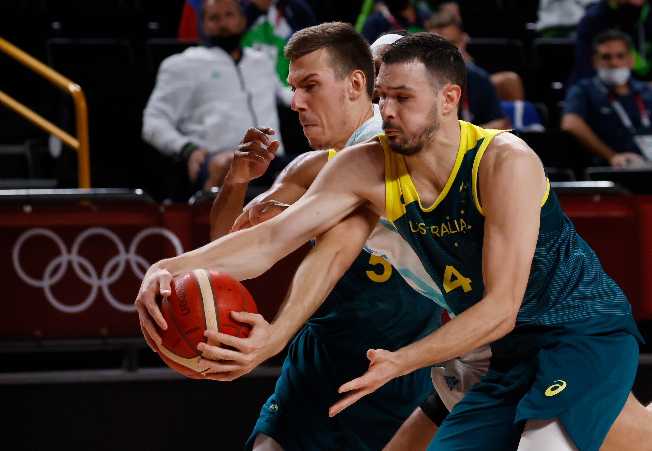 Slovenia’s Vlatko Cancar (31) and Australia’s Chris Goulding (4) fight for a loose ball...