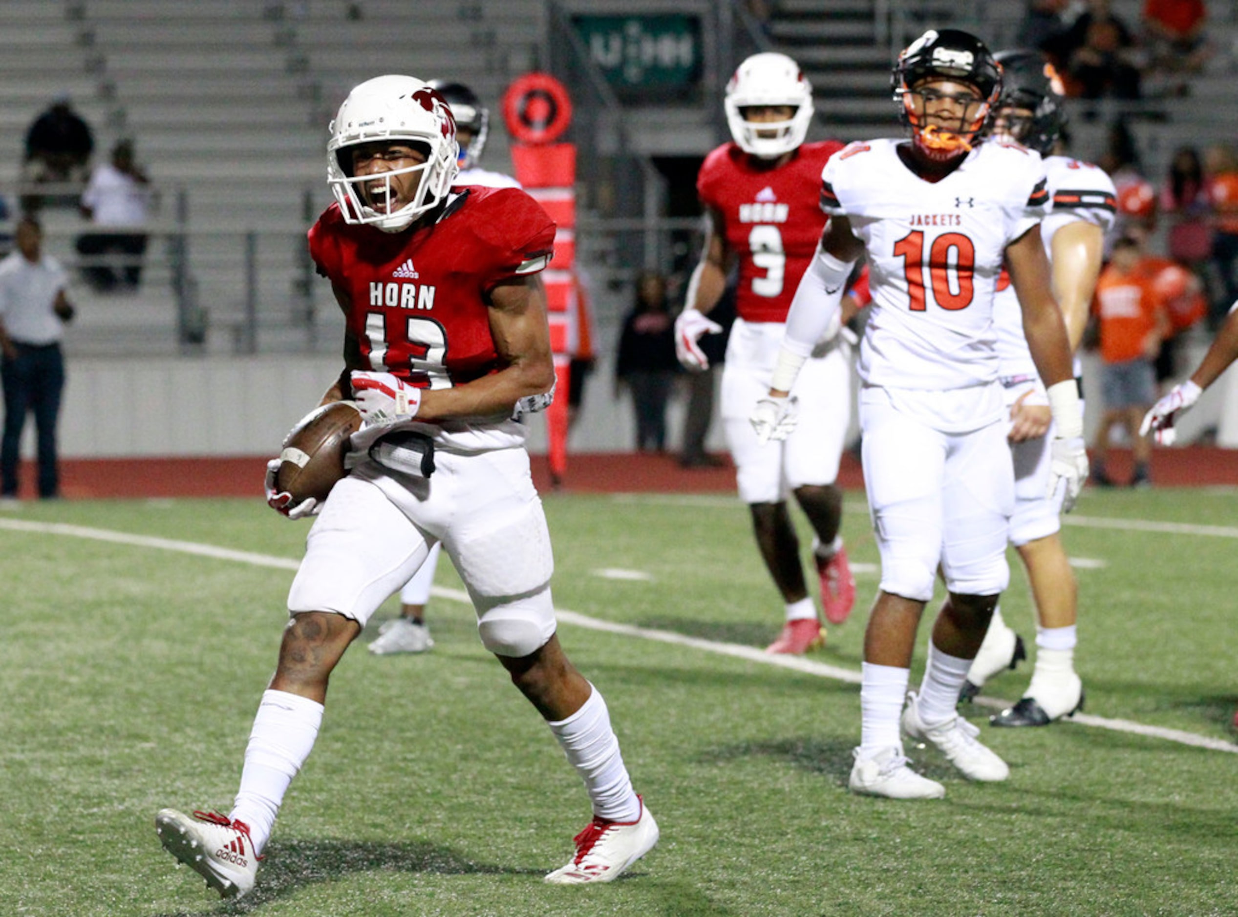 Mesquite Horn's Cornell Caldwell (13) screams in the end zone, as Rockwall defender Drew...