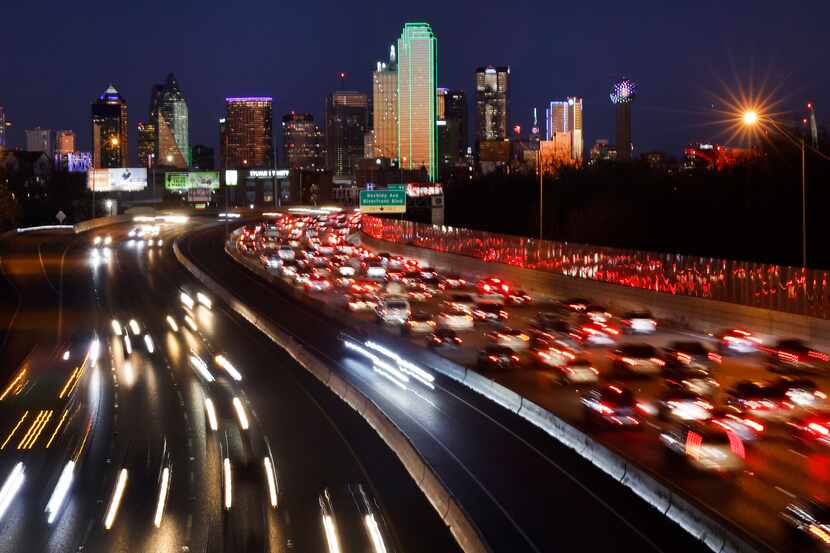 Traffic is backed up on eastbound Interstate 30 (right) as it approaches downtown Dallas on...