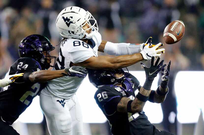 TCU Horned Frogs safety Vernon Scott (26) looks to pick off a tipped pass to West Virginia...