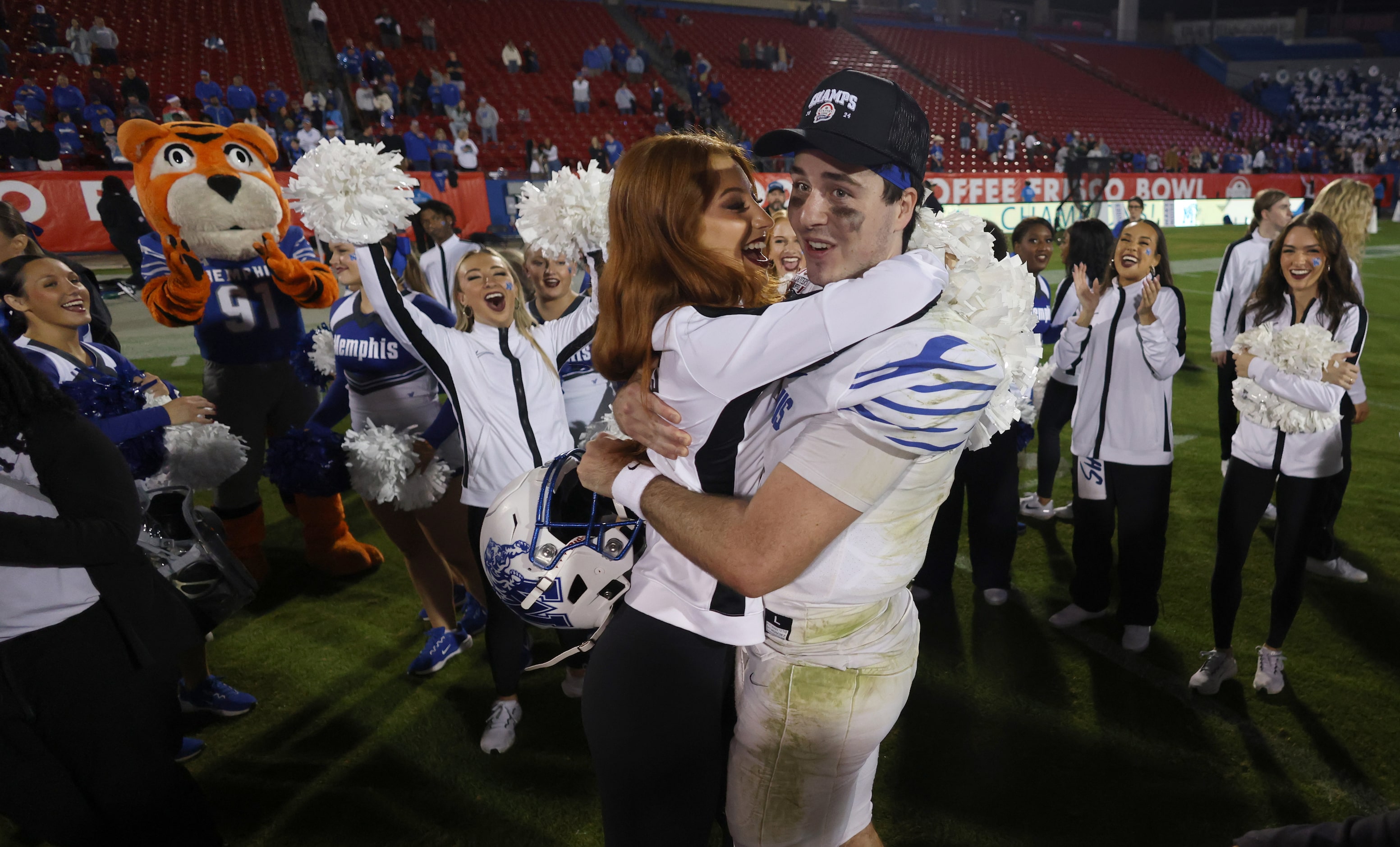 Memphis quarterback Seth Henigan (9) received a hug at midfield from his finance' following...