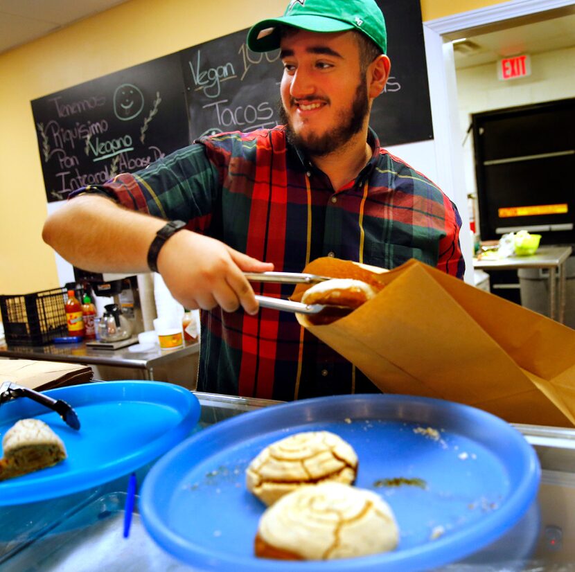 Aaron Arias bags some pastries for a customer at El Palote, a Vegan Mexican restaurant in...