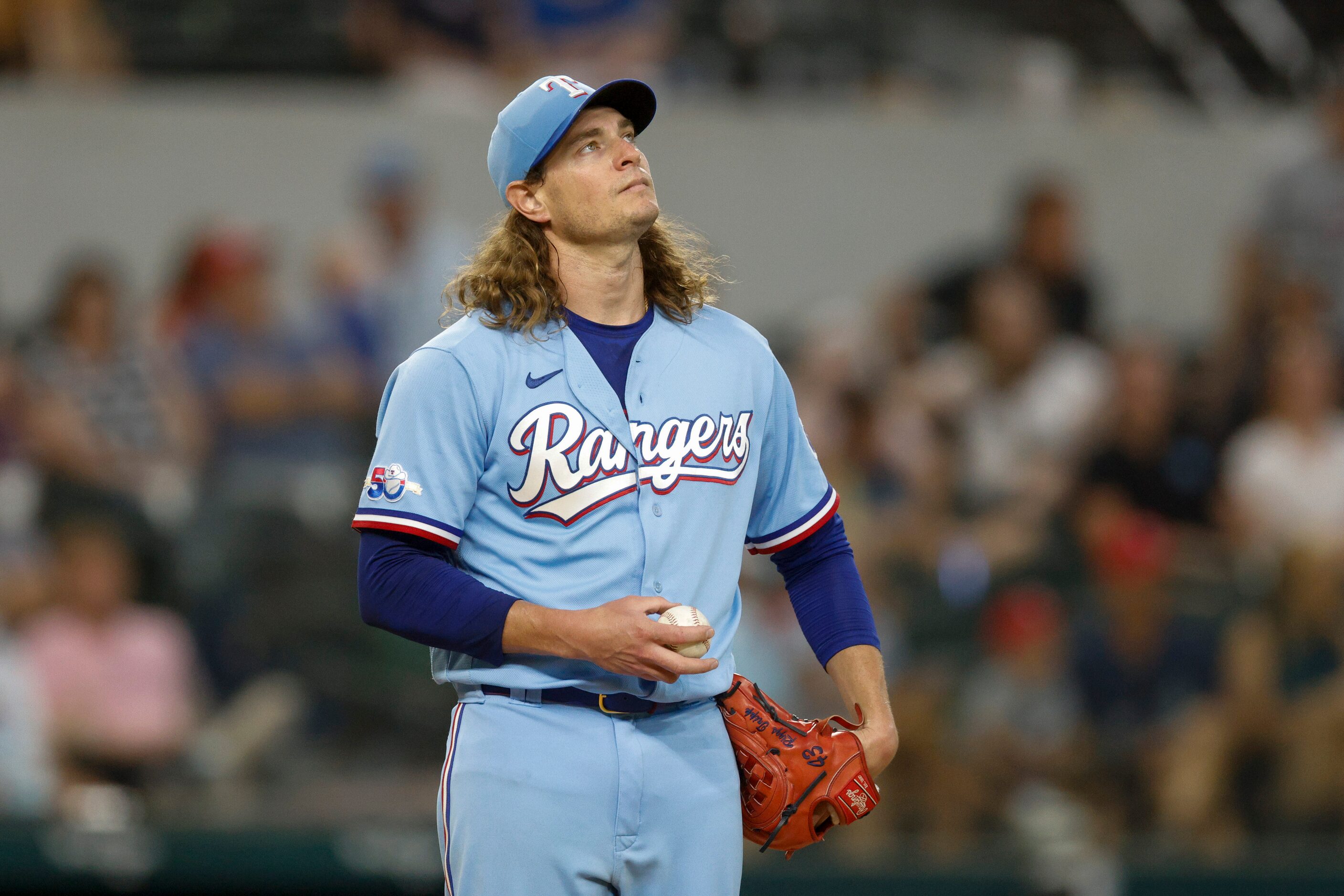 Texas Rangers relief pitcher Garrett Richards (43) watches a replay on the video board after...