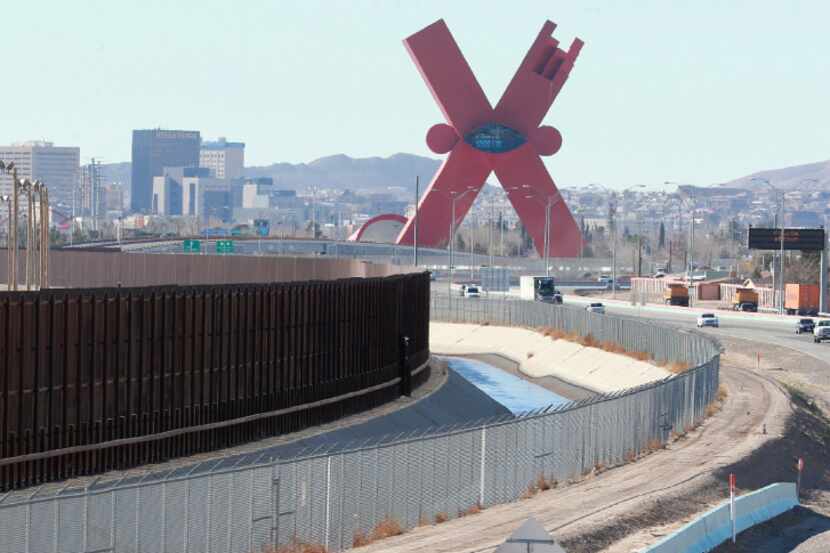Traffic moves on the El Paso border highway, right, next to the border fence the separates...