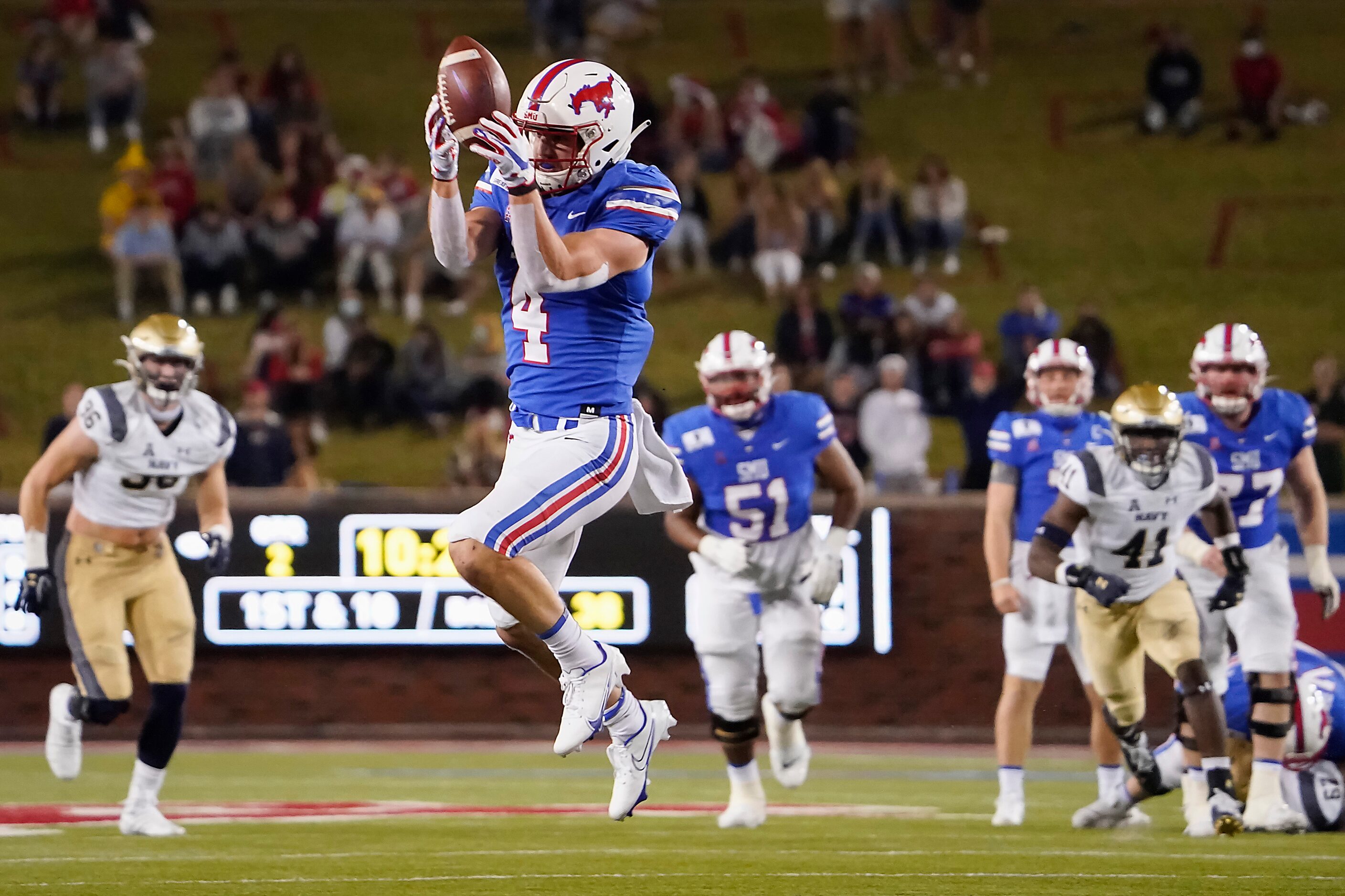 SMU wide receiver Tyler Page (4) hauls in a pass from quarterback Shane Buechele during the...