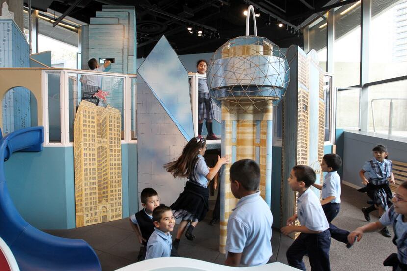 Kids play in the Dallas Skyline Climber on the lower level at the Perot Museum of Nature and...